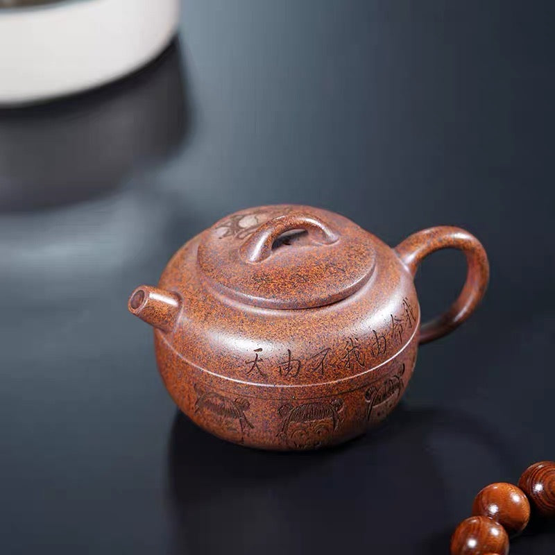 Carving Nezha Handuo Pot in the Clay of Yixing Zisha Pot Raw Mine by Hand-burning.